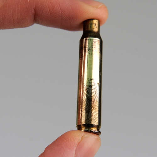 Bullet with recovered fingermark.