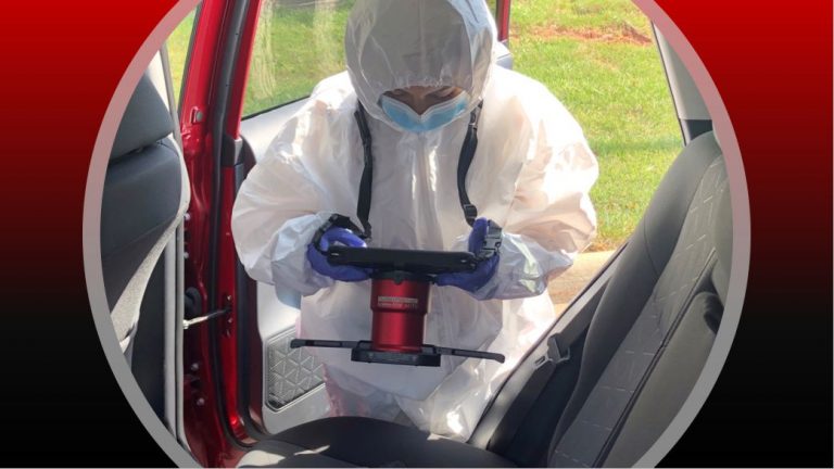 Crime-lite forensic light source being used by a forensic examiner.